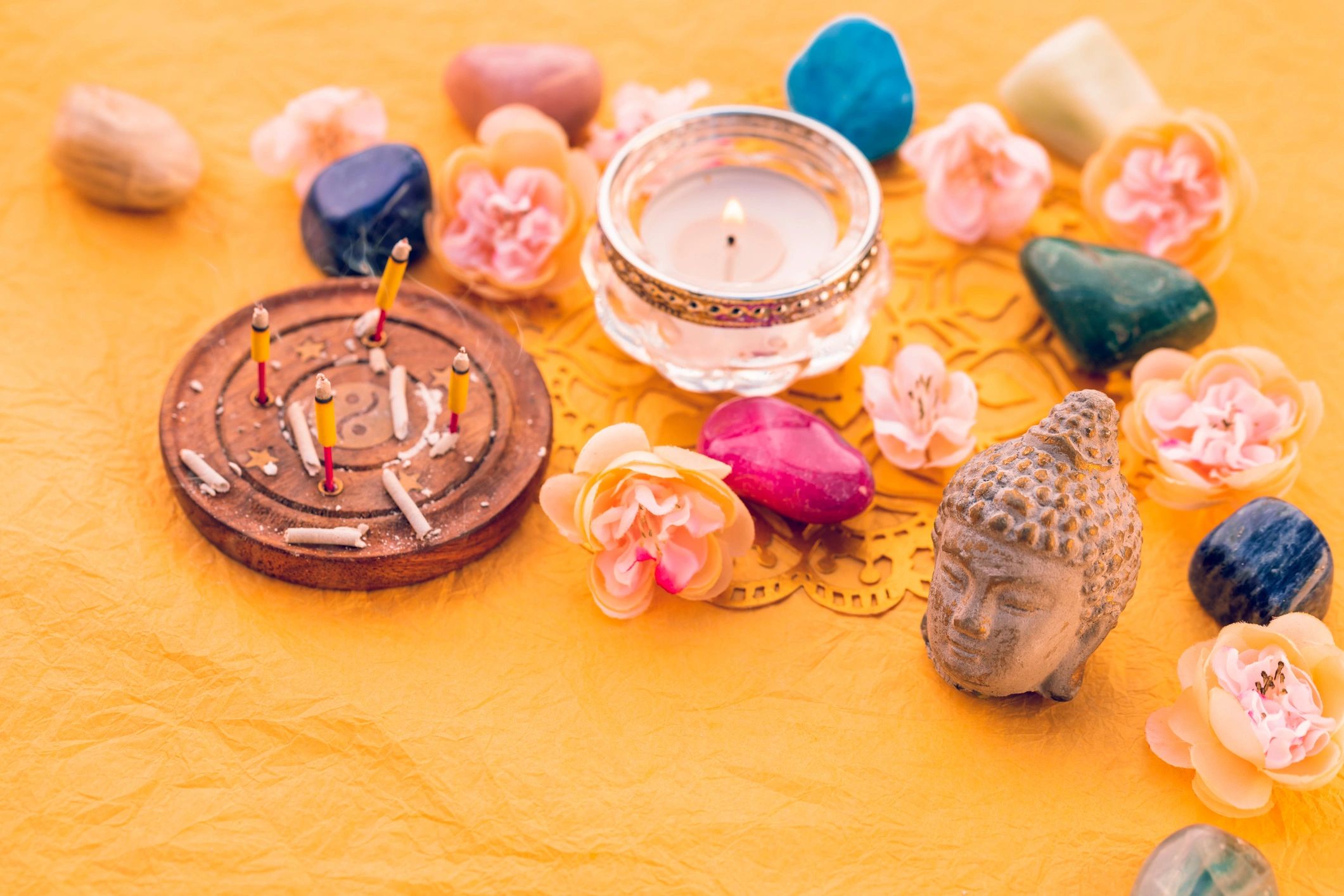 Healing stones and incense arranged for spiritual practice
